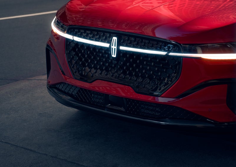 The available front LED light bar and center Lincoln Star logo glow at dusk. | Bill Collins Lincoln of Louisville in Louisville KY
