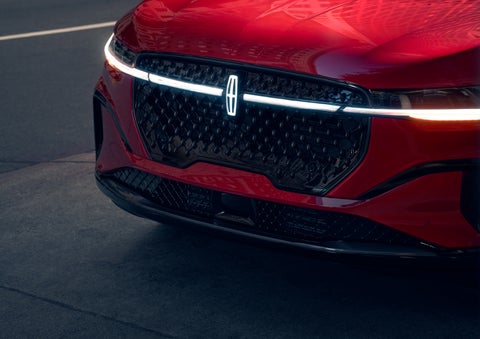 The available front LED light bar and center Lincoln Star logo glow at dusk. | Bill Collins Lincoln of Louisville in Louisville KY