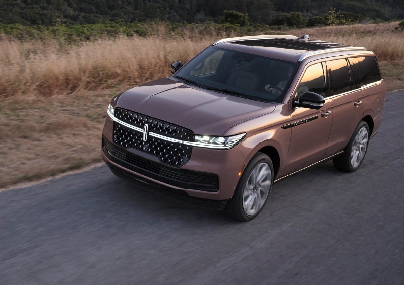 The Lincoln Star of a 2025 Lincoln Navigator® SUV is elegantly illuminated.