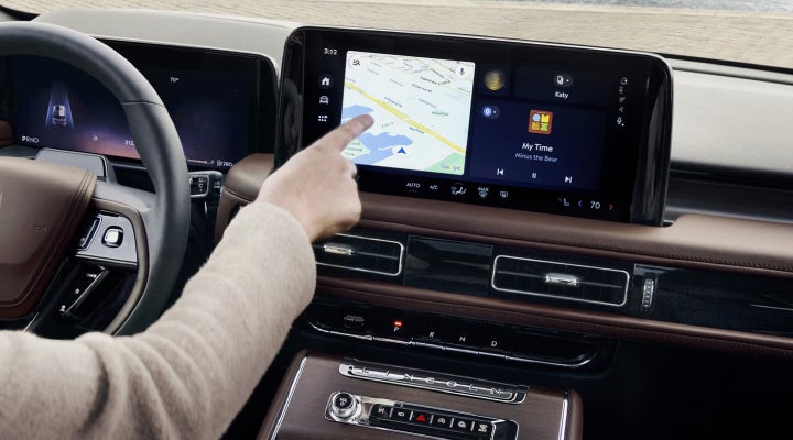 A person is tapping the center display touchscreen of a 2026 Lincoln Aviator® SUV. | Bill Collins Lincoln of Louisville in Louisville KY