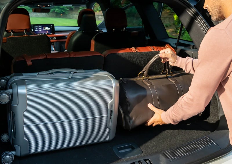 A man loads luggage into the rear of a 2026 Lincoln Aviator® SUV through the opened rear liftgate. | Bill Collins Lincoln of Louisville in Louisville KY