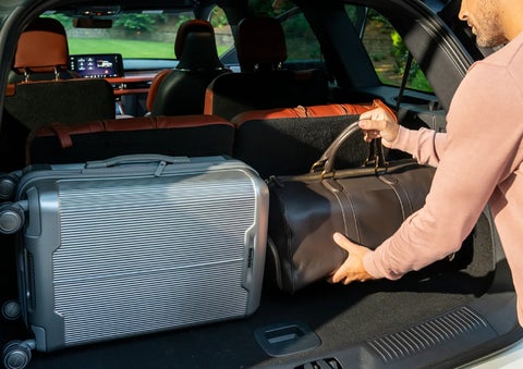 A man loads luggage into the rear of a 2026 Lincoln Aviator® SUV through the opened rear liftgate. | Bill Collins Lincoln of Louisville in Louisville KY