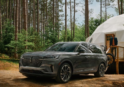 A 2027 Lincoln Aviator® is parked next to a high end glamping site. | Bill Collins Lincoln of Louisville in Louisville KY