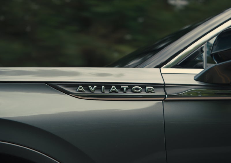 The driver’s side door and fender badging of a gray 2027 Lincoln Aviator® SUV are showcased. | Bill Collins Lincoln of Louisville in Louisville KY