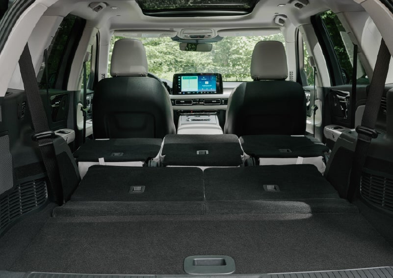 A rear to front view of the interior of a 2027 Lincoln Aviator® Black Label™ SUV shows the third and second rows folded flat | Bill Collins Lincoln of Louisville in Louisville KY