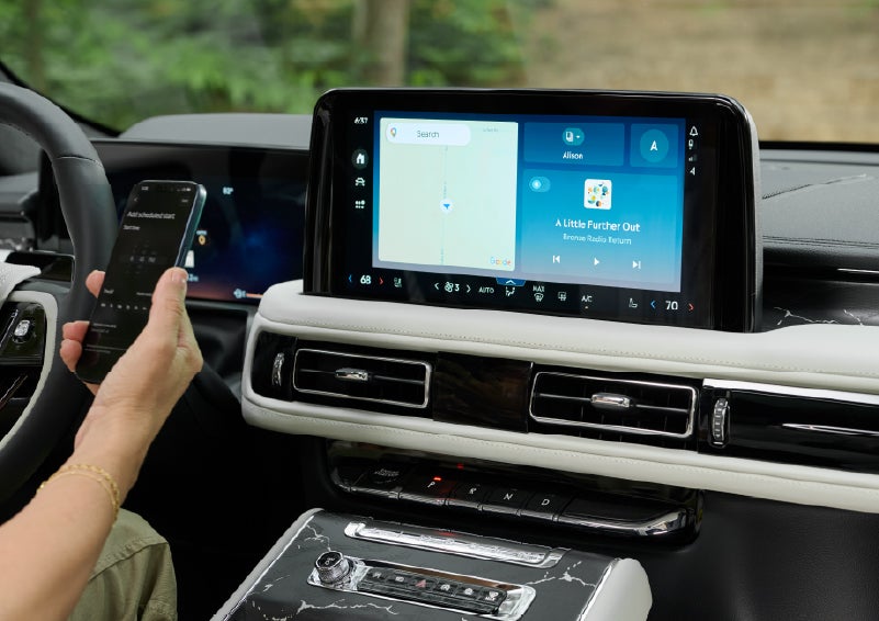 A person pairs thier phone with the center touchscreen of a 2027 Lincoln Aviator® Black Label™ SUV | Bill Collins Lincoln of Louisville in Louisville KY